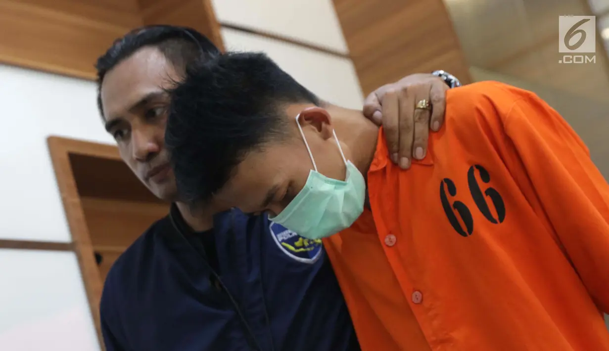 Petugas DirTipidsiber Bareskrim Polri menggiring satu tersangka peretasan situs Kemendagri jelang rilis di Mabes Polri, Jakarta, Jumat (27/9/2019). DirTipidsiber Bareskrim Polri mengungkap dan menangkap tersangka peretasan situs Kemendagri. (Liputan6.com/Helmi Fithriansyah)