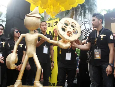 Sejumlah Polisi berpose dengan replika rol film, Jakarta, Minggu (16/4). Memperingati ulang tahun Korps Polri ke-72, festival film pendek dan film animasi bertajuk Police Movie Festival digelar untuk yang keempat kalinya. (Liputan6.com/Angga Yuniar)