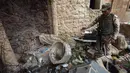 Seorang tentara Irak berjalan di puing bangunan Gereja St. George Monastery (Mar Guguis) di Mosul, 22 Januari 2017. Tak hanya merusak, ISIS juga menjarah dan membakar salah satu gereja bersejarah di Irak tersebut pada 2014 lalu. (AHMAD AL-RUBAYE/AFP)