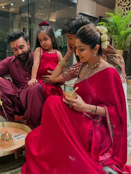 Shilpa Shetty Kundra tampil mengenakan saree merah terdiri dari atasan lengan pendek crop dihiasi beads dan selendang serasi dengan roknya. [@theshilpashetty]