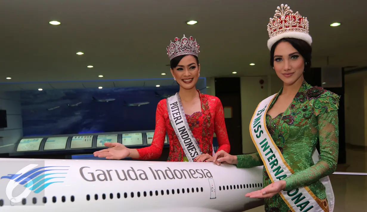 Miss Internasional 2015, Edymar Martinez beserta Putri Indonesia 2016, Kezia Roslin Cikita Warouw berpose direplika pesawat Garuda Indonesia di sela kunjungan ke Garuda Indonesia Training Center, Jakarta, (22/2). (Liputan6.com/Herman Zakharia)