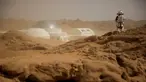 Seorang staf menggunakan pakaian astronot berada di dekat markas simulasi C-Space Project Mars yang berada di gurun Gobi, Jinchang, Provinsi Gansu, China (18/4). Kota Jinchang meningkatkan pariwisata dengan membuat para pengunjung merasa berada di planet Mars. (Reuters/Thomas Peter)
