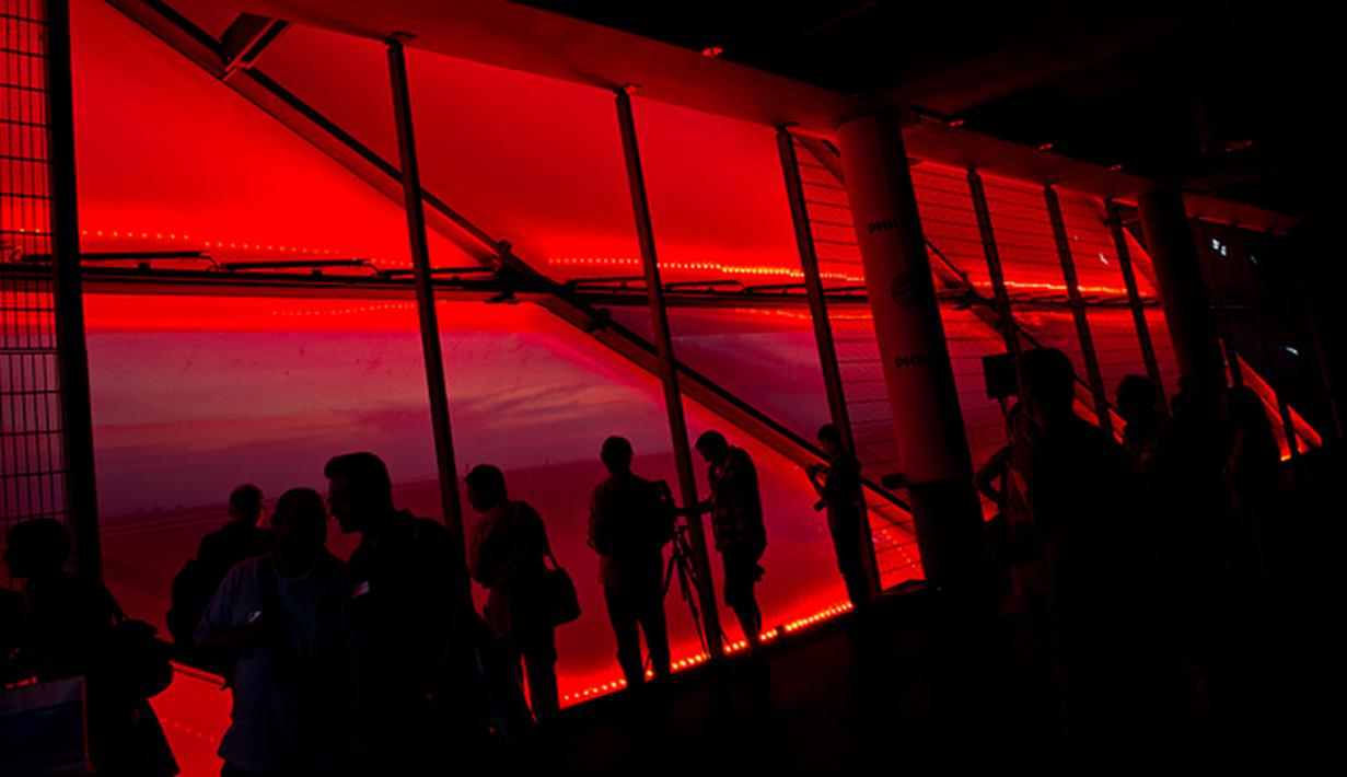 Sejumlah warga menikmati pesona lampu LED baru yang terpasang di Stadion Allianz Arena, Jerman, Rabu (12/8/2015). (EPA/Sven Hoppe)