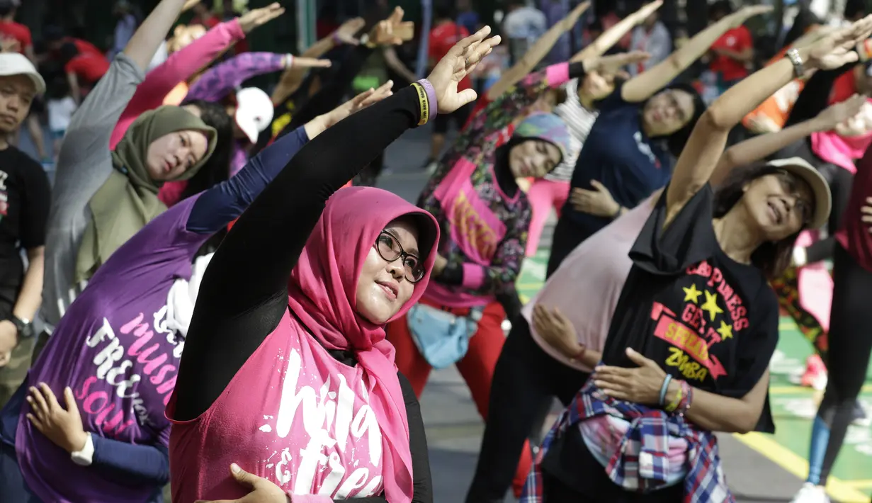 Sejumlah warga mengikuti senam Zumba di Kawasan Semanggi, Jakarta, Minggu (6/10/2019). Selain bisa membakar kalori dan bermanfaat untuk kesehatan jantung, olahraga ini juga bisa mencegah stress dan memperbaiki mood. (Bola.com/M Iqbal Ichsan)