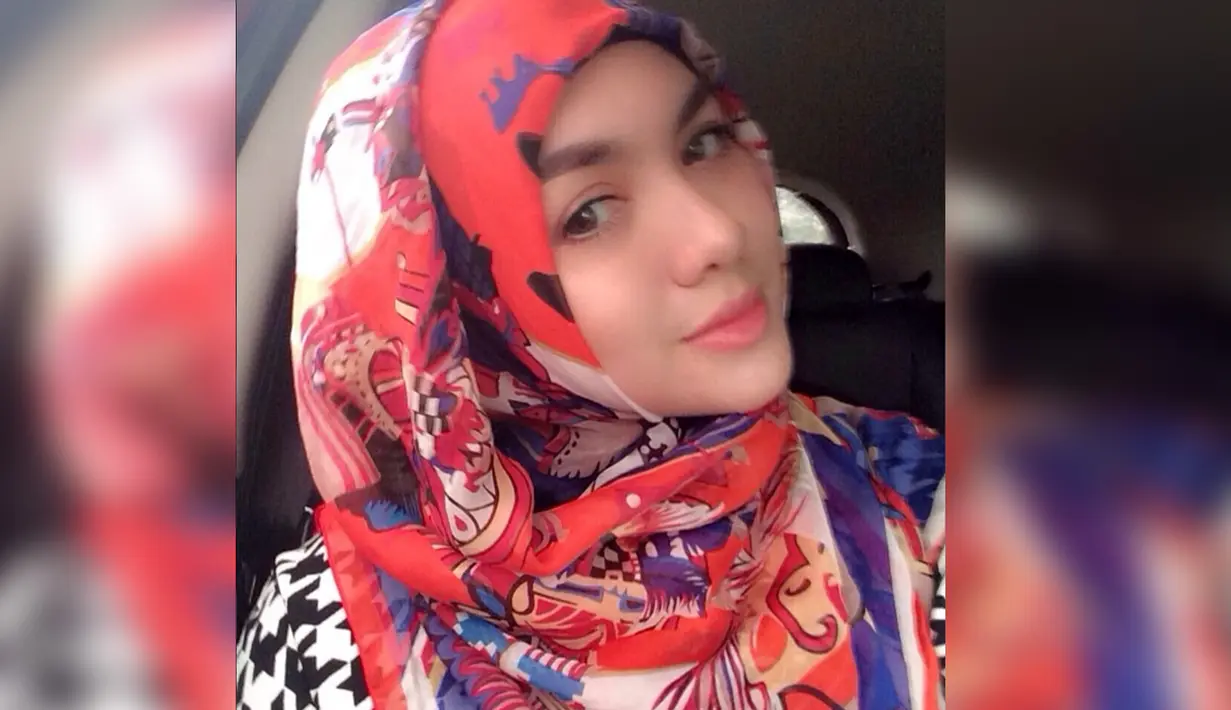Vicky Shu tampil anggun dan menawan saat mengenakan hijab bermotif abstrak dengan warna dominan merah. (Instagram.com/Vickyshu)