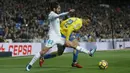 Aksi pemain Real Madrid, Francisco Roman "Isco" (kiri) berebut bola dengan pemain Las Palmas, Joaquin "Ximo" Navarro pada laga La Liga Santander di Santiago Bernabeu stadium, Madrid, (5/11/2017). Real Madrid menang 3-0. (AP/Francisco Seco)