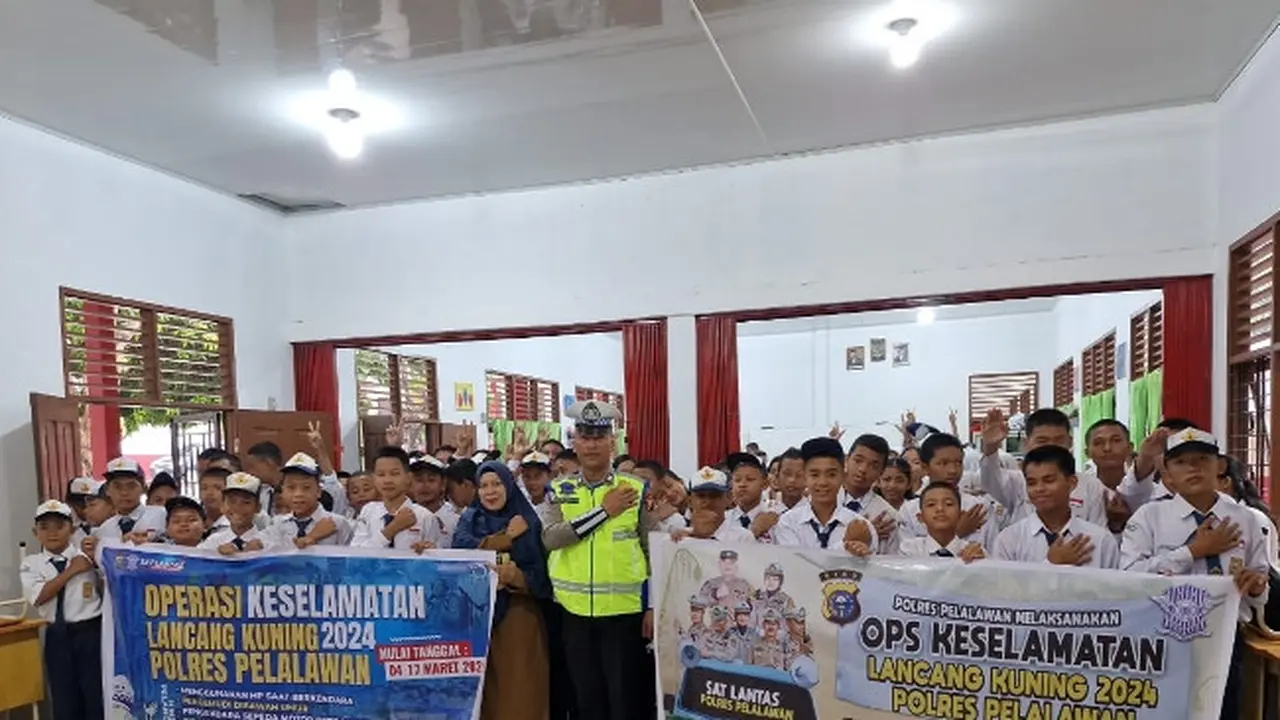 Personel Polres Pelalawan bersama puluhan pelajar dalam program Goes To School Operasi Keselamatan Lancang Kuning.