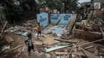 Dua orang bocah bermain di bongkaran bangunan yang terletak di bantaran sungai Ciliwung, Bukit Duri, Jakarta, Rabu (5/7). Pemerintah akan melaksanakan rencana penertiban bangunan di bantaran sungai Ciliwung. (Liputan6.com/Faizal Fanani)