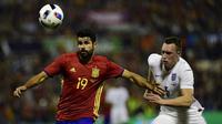 Striker Spanyol, Diego Costa (kiri), mendapat kawalan bek Inggris, Phil Jones (kanan), pada laga persahabatan di Stadion Jose Rico Perez, Alicante, Sabtu (14/11/2015) dini hari WIB. (AFP PHOTO / Pierre-Philippe Marcou)