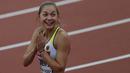 Ekspresi Atlet cantik asal Jerman, Gina Luckenkemper usai menjuarai 100m putri pada ajang IAAF World Championships 2017 di London Stadium, (5/8/2017). (AFP/Adrian Dennis)