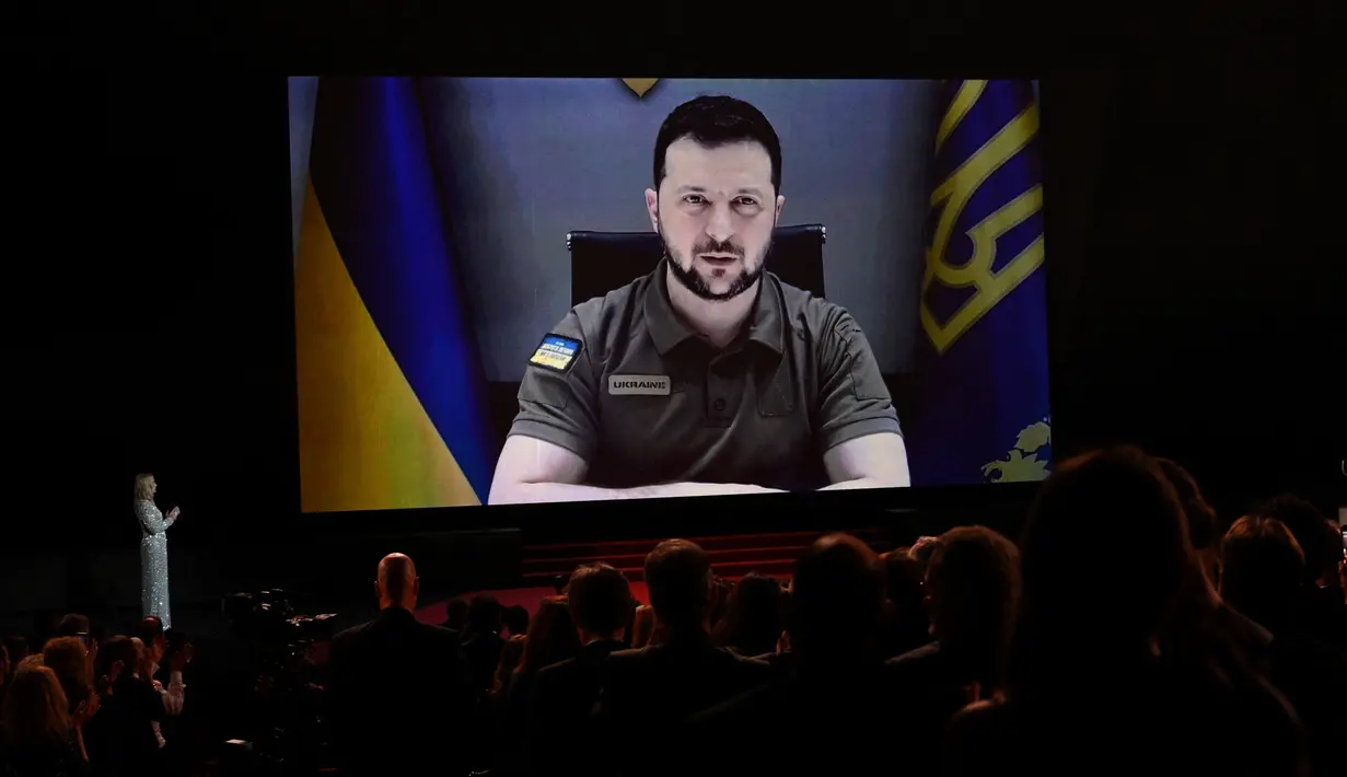 Presiden Ukraina Volodymyr Zelensky menyampaikan pidato lewat video yang disetel saat upacara pembukaan Festival Film Cannes edisi ke-75 di Cannes, Prancis selatan, Selasa (17/5/2022). Dalam pidatonya, Zelensky menyinggung keterlibatan dunia film dan sinema dalam menjaga persatuan dunia. (AFP/CHRISTOPHE SIMON)