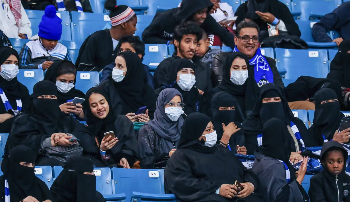 Sejumlah wanita menonton pertandingan sepak bola antara Al-Hilal melawan Al-Ittihad di King Fahd International Stadium di Riyadh (13/1). Akhirnya wanita di Arab Saudi dibolehkan menonton pertandingan olahraga secara langsung. (AFP Photo/Ali Al-Arifi)