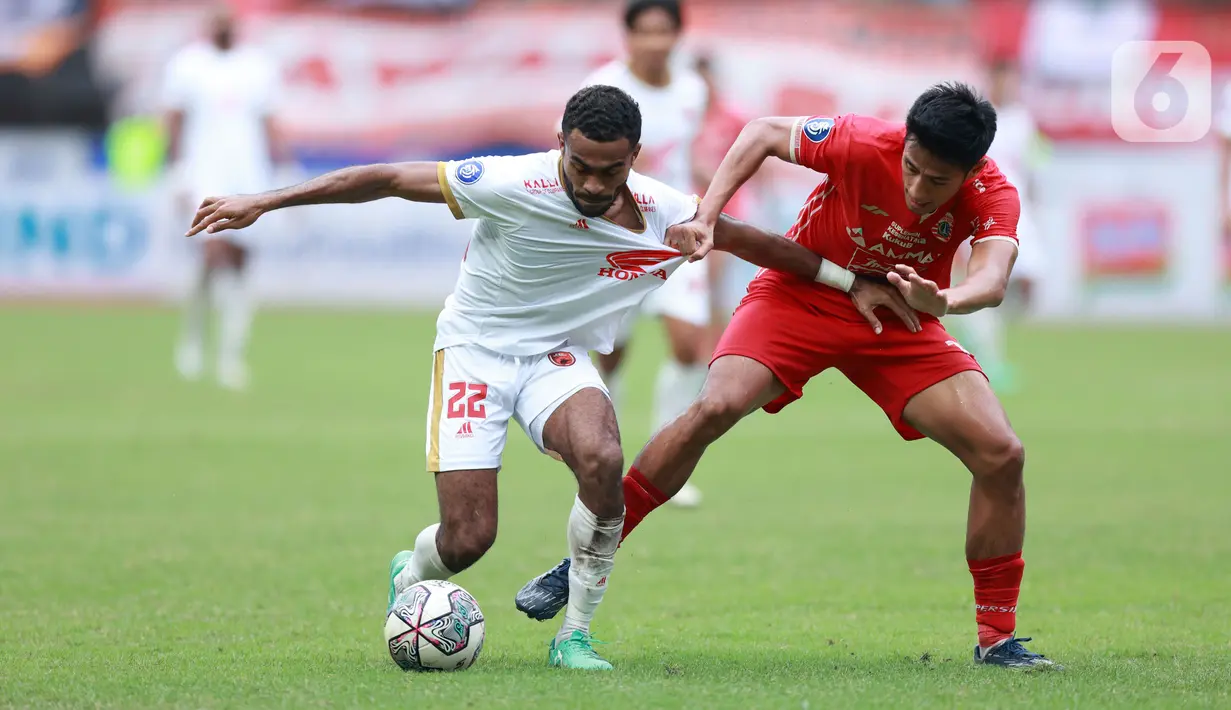 Pemain Persija Jakarta, Hanif Sjahbandi, berebut bola dengan pemain PSM Makassar, Yakob Sayuri, pada laga pekan ke-20 BRI Liga 1 2022/2023 di Stadion Patriot Candrabhaga, Bekasi, Rabu (25/1/2023). Persija menang dengan skor 4-2. (Bola.com/M Iqbal Ichsan)