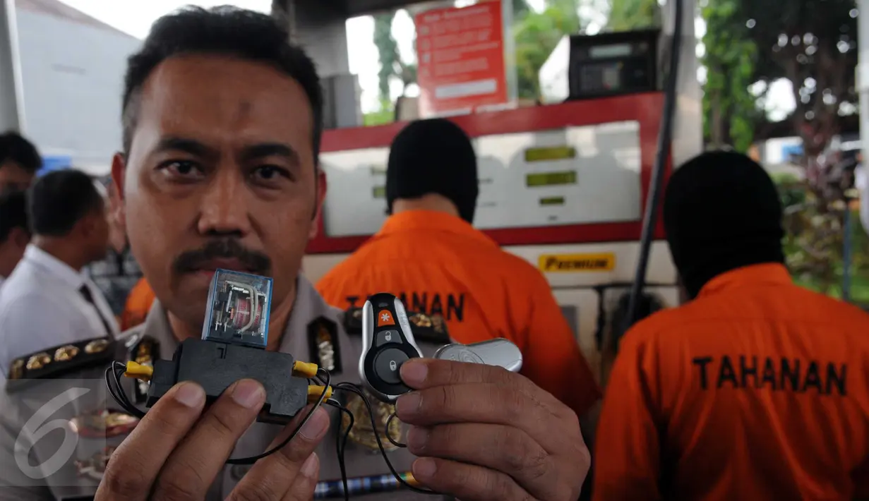 Petugas menunjukkan barang bukti kasus praktik pengurangan literan di SPBU kawasan Rempoa, Ciputat, Tangsel, Senin (6/6). Modus yang dilakukan adalah dengan mengurangi jatah bahan bakar menggunakan digital regulator stabilizer. (Liputan6.com/Helmi Afandi)