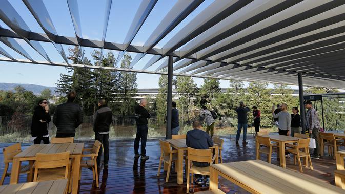 Pengunjung naik ke teras atap Visitor Center di kawasan Apple Park yang resmi dibuka untuk umum di Cupertino, California, Jumat (17/11). Pengunjung bisa melihat megahnya markas baru Apple dan 9.000 pohon yang ada di sana. (AP/Eric Risberg)