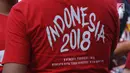 Tulisan dari kaus salah satu peserta gelaran Harmoni Indonesia 2018 di Kompleks Gelora Bung Karno, Jakarta, Minggu (5/8). Acara ini bagian perayaan HUT RI ke-73 dan menyambut Asian Games 2018. (Liputan6.com/Helmi Fithriansyah)
