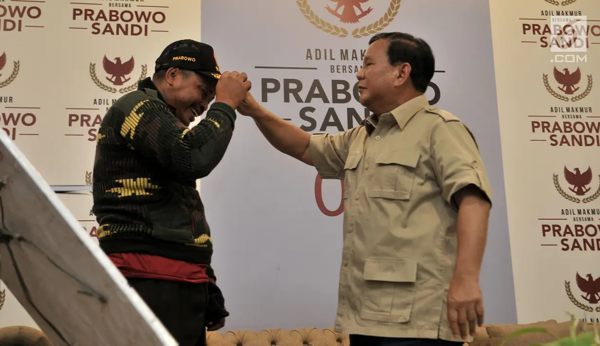 Calon Presiden nomor urut 02 Prabowo Subianto memberikan topi untuk Rahman relawan yang berjalan kaki dari Tegal di Kantor BPN Prabowo-Sandi, Kertanegara, Jakarta (20/12). (Merdeka.com/Iqbal S. Nugroho)
