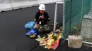 Seorang pawang hujan melakukan ritual saat sesi latihan bebas MotoGP Indonesia di Sirkuit Mandalika, Mandalika, Lombok Tengah, Nusa Tenggara Barat, Jumat (18/3/2022). (AFP/Bay Ismoyo)