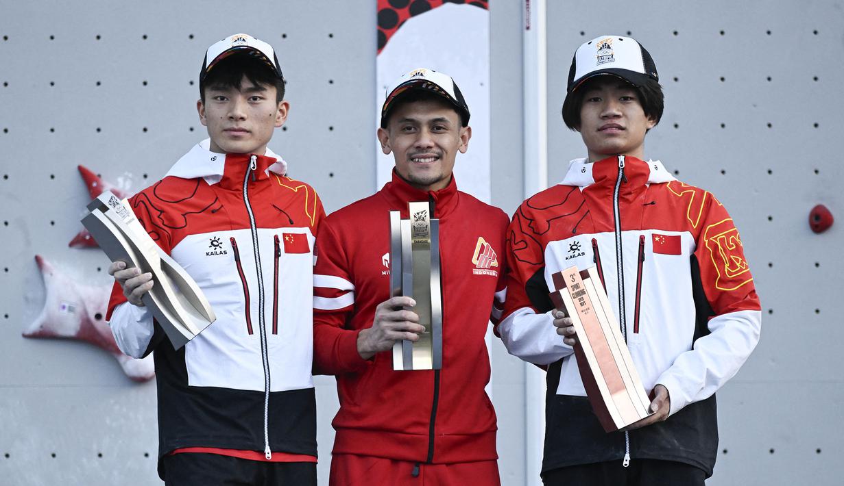 Atlet panjat tebing Indonesia, Veddriq Leonardo (tengah) menjadi juara dalam ajang Kualifikasi Olimpiade 2024 panjat tebing nomor speed di Shanghai, China, Sabtu (18/05/2024) waktu setempat. (AFP/Wang Zhao)
