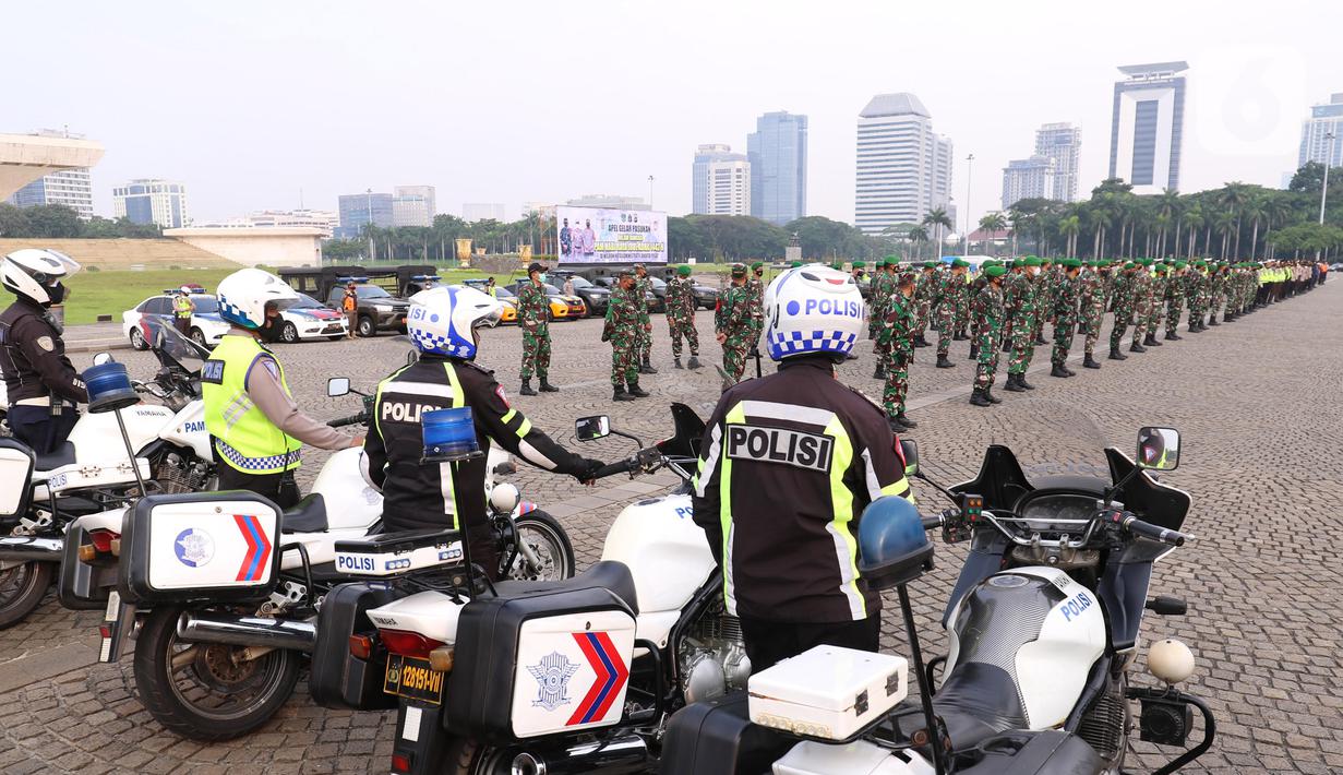 Personil gabungan melakukan apel pasukan pengamanan di Monas, Jakarta, Senin (19/7/2021). Pengamanan tersebut dilakukan untuk menjaga Hari Raya Idul Adha 1442 Hijriah dimasa pandemi Covid-19 saat PPKM Darurat. (Liputan6.com/Angga Yuniar)