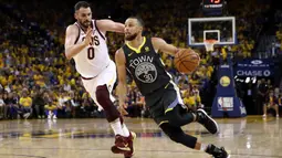 Pebasket Golden State Warriors, Stephen Curry, berusaha melewati pebasket Cleveland Cavaliers, Kevin Love, pada final NBA di Oracle Arena, Oakland, Minggu (3/6/2018). Warriors menang 122-103 atas Cavaliers. (AFP/Ezra Shaw)