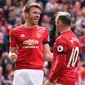 Wayne Rooney (kanan) bersama Michael Carrick merayakan gol Manchester United ke gawang Swansea City pada laga Premier League di Old Trafford, Manchester, Minggu (30/4/2017). (AFP/Oli Scarff)