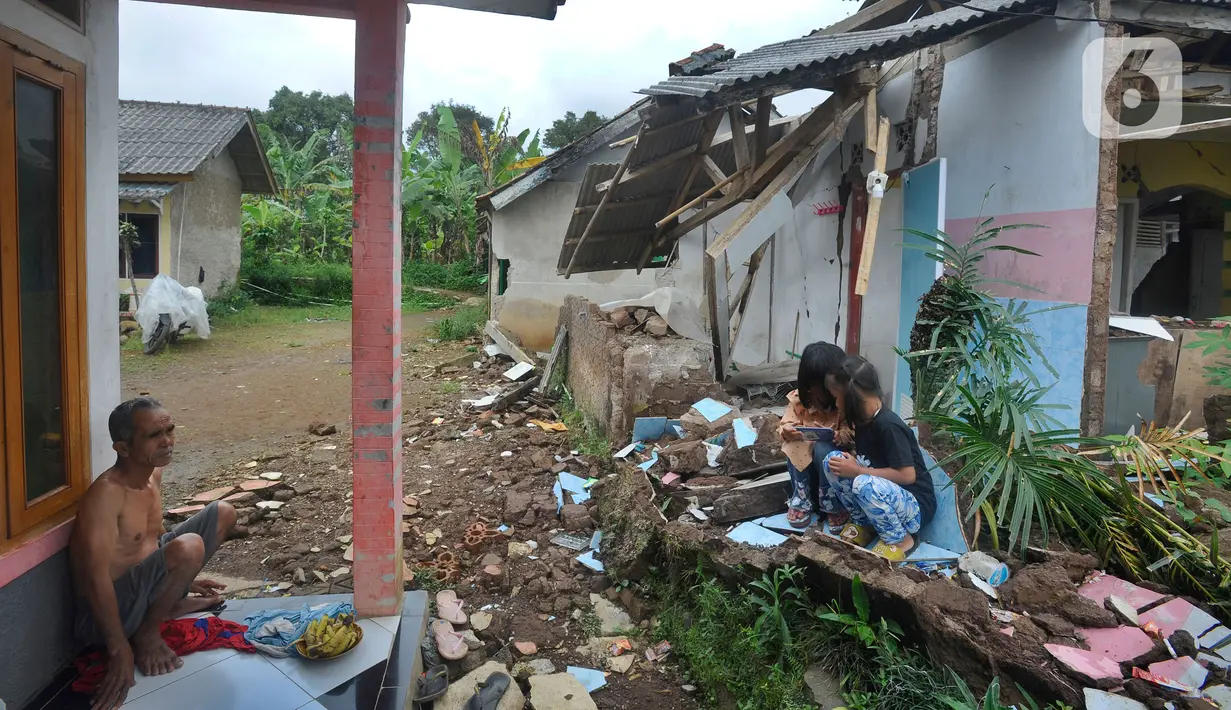 Anak-anak bermain hp di Desa Mangunkerta, tCianjur, Jumat (23/12/2022). Lebih dari sebulan sejak musibah gempa bumi 5,2 SR sejumlah warga masih tinggal di pengungsian dan hunian sementara dengan bantuan kebutuhan hidup dari para donatur. (merdeka.com/Arie Basuki)