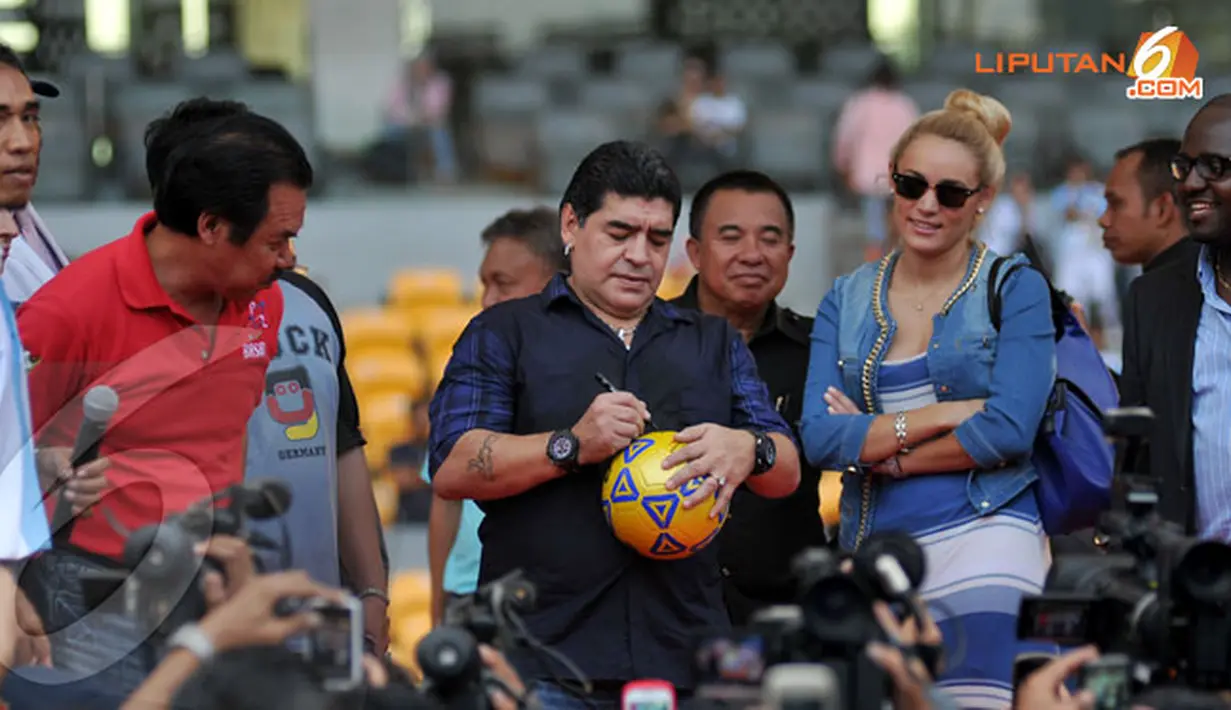 Diego Maradona menandatangani serta membagikan bola kepada penggemarnya di Stadion Gelora Bung Karno Jakarta pada Sabtu 29 Juni 2013 (Liputan6.com/Helmi Fithriansyah)