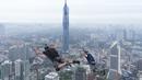 Sepasang pelompat BASE terjun dari Menara Kuala Lumpur selama KL Tower International Jump Malaysia di Kuala Lumpur, Jumat (3/2/2023). Ini merupakan salah satu olahraga ekstrim yang memicu adrenalin dan membuat penasaran para pengunjung. (AP Photo/Vincent Thian)