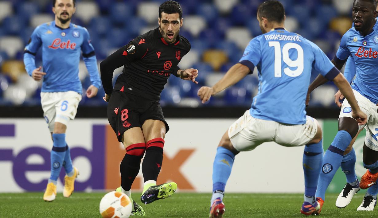 Gelandang Real Sociedad, Mikel Merino mengoper bola saat melawan Napoli pada matchday terakhir Grup F Liga Europa di Diego Armando Maradona, Jumat (11/12/2020) dini hari WIB. Napoli bermain imbang 1-1 melawan Real Sociedad. (Alessandro Garofalo/LaPresse via AP)