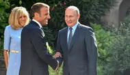 Presiden Prancis Emmanuel Macron (tengah) dan istrinya Brigitte (kiri) menyambut Presiden Rusia Vladimir Putin di Benteng Bregancon, Bormes-les-Mimosas, Prancis, Senin (19/8/2019). Putin menemui Macron untuk membahas krisis dunia. (Gerard Julien, Pool via AP)