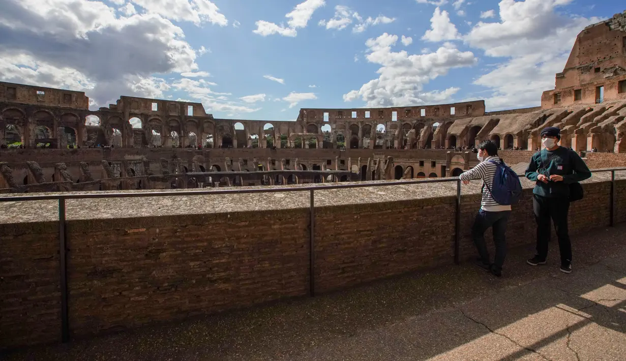Wisatawan mengunjungi Colosseum di Roma, Sabtu (7/3/2020). Kekhwatiran terhadap virus corona (COVID-19) membuat tempat-tempat pariwisata di Italia sepi pengunjung, seperti di kawasan Colosseum yang merupakan salah satu dari keajaiban dunia. (AP Photo/Andrew Medichini)