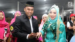 Pasangan nikah massal meluapkan kebahagiaan usai ijab kabul di jalan MH Thamrin, Jakarta, Senin (31/12). 557 pasangan mengikuti nikah massal dan isbat nikah pada malam pergantian tahun 2018-2019. (Liputan6.com/Helmi Fithriansyah)