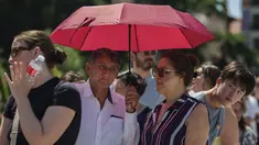 Pasangan berlindung dari terik matahari saat musim panas di Madrid, Spanyol, Sabtu, 8 Juli 2023. (AP Photo/Manu Fernandez)