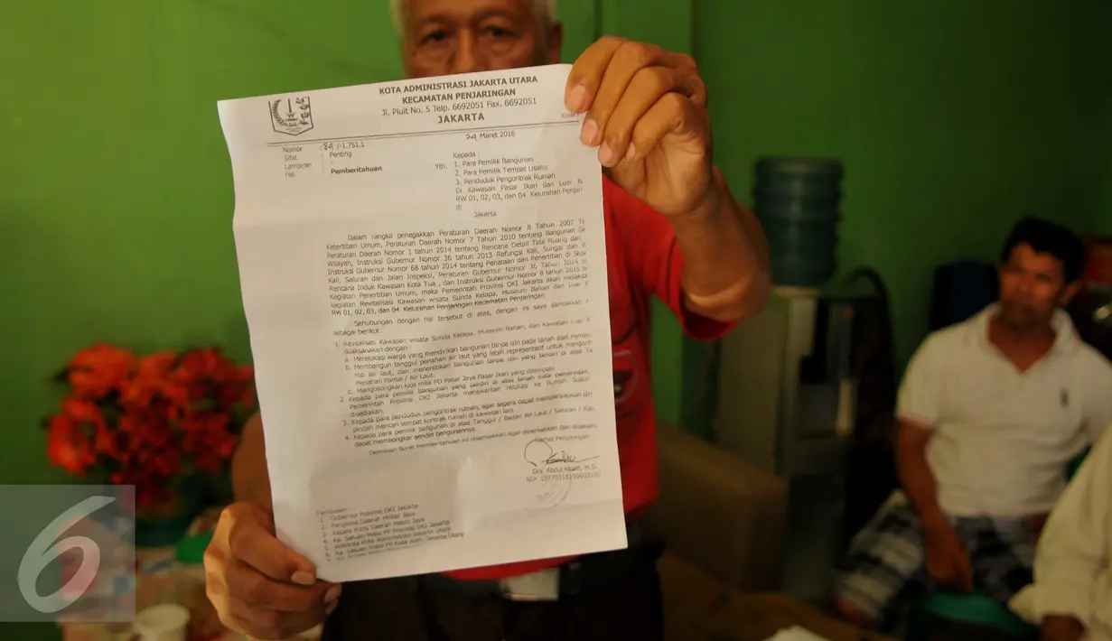 Warga menunjukkan surat pemberitahuan dari Kecamatan Penjaringan di Kampung Aquarium, Jakarta Utara, Senin (28/3). Surat pemberitahuan berisi penertiban hunian yang menempati Kawasan Pasar Ikan dan Luar Batang. (Liputan6.com/Gempur M Surya)