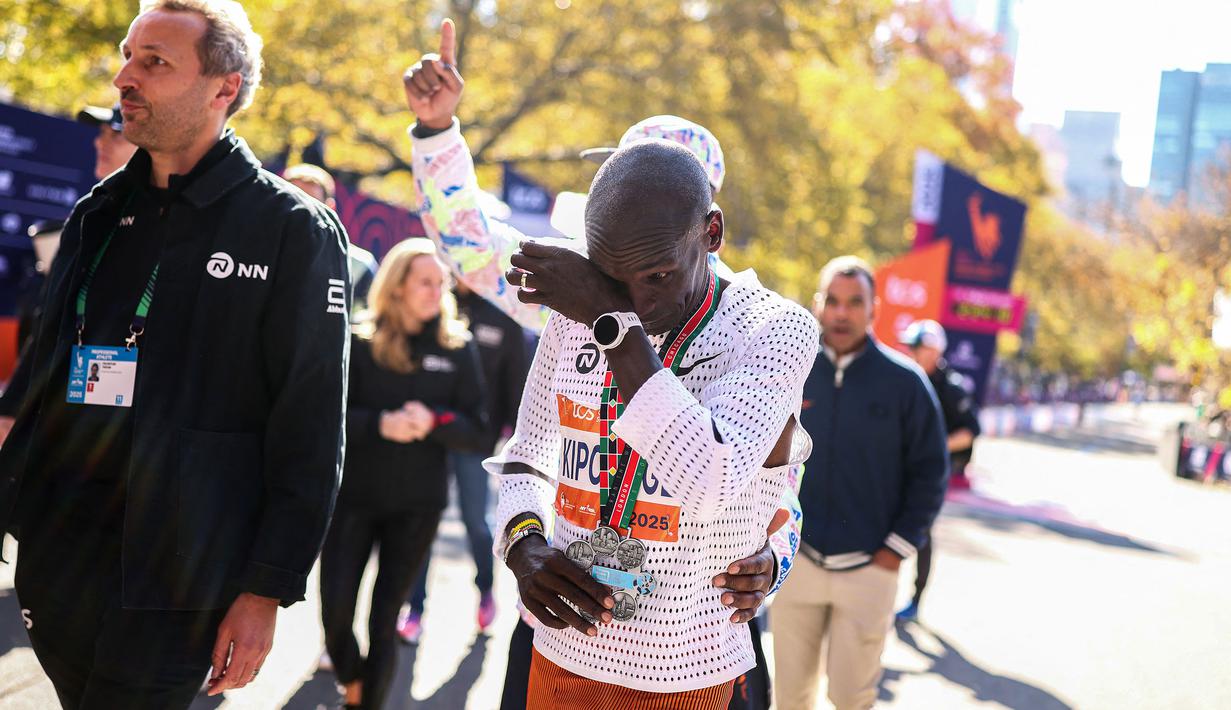 Pelari Kenya, Eliud Kipchoge menyeka air matanya setelah berhasil menyabet medali Sixth Star setelah menyelesaikan New York Marathon 2025 pada Minggu (02/11/2025) waktu setempat. (AFP/Charly Triballeau)