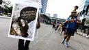 Suasana aksi sosialisasi penyelamatan hewan orangutan Indonesia di Jalan Sudirman, Jakarta Pusat, Minggu (30/11/2014).(Liputan6.com/Faizal Fanani) 