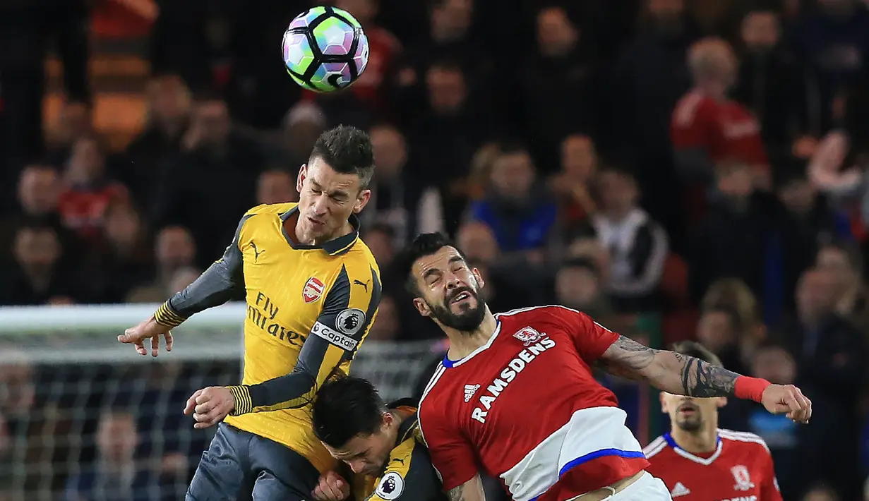 Bek Arsenal, Laurent Koscielny, duel udara dengan striker Middlesbrough, Alvaro Negrado, pada laga Premier League di Stadion Riverside, Inggris, Senin (17/4/2017). Middlesbrough takluk 1-2 dari Arsenal. (AFP/Lindsey Parnaby)