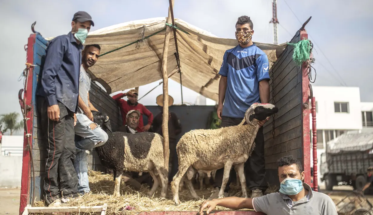 Pedagang mengenakan masker saat menunggu pelanggan membeli domba untuk perayaan Idul Adha di sebuah pasar di pinggiran Rabat, Maroko, Kamis (30/7/2020). (AP Photo/Mosaab Elshamy)