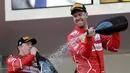 Pembalap Ferrari, Sebastian Vettel menyemprotkan sampanye saat merayakan kemenangannya pada balapan GP Monaco di Sirkuit Monte Carlo, Minggu (28/5). Vettel finis pada urutan pertama dengan waktu satu jam 44 menit 44,340 detik (AP Photo/Claude Paris)