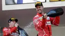Pembalap Ferrari, Sebastian Vettel menyemprotkan sampanye saat merayakan kemenangannya pada balapan GP Monaco di Sirkuit Monte Carlo, Minggu (28/5). Vettel finis pada urutan pertama dengan waktu satu jam 44 menit 44,340 detik (AP Photo/Claude Paris)
