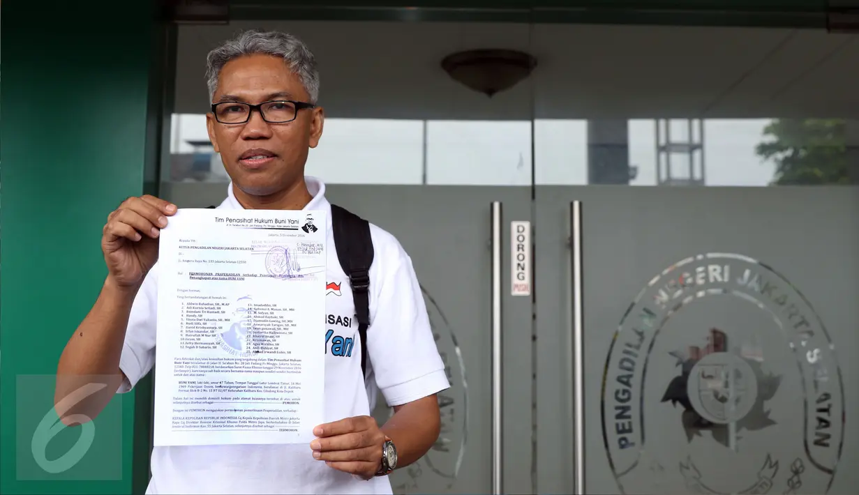 Buni Yani menunjukkan surat permohonan praperadilan di PN Jakarta Selatan, Senin (5/12). Sebelumnya, Buni Yani ditetapkan sebagai tersangka dugaan kasus penyebaran informasi yang menimbulkan permusuhan berdasarkan SARA. (Liputan6.com/Helmi Fithriansyah)