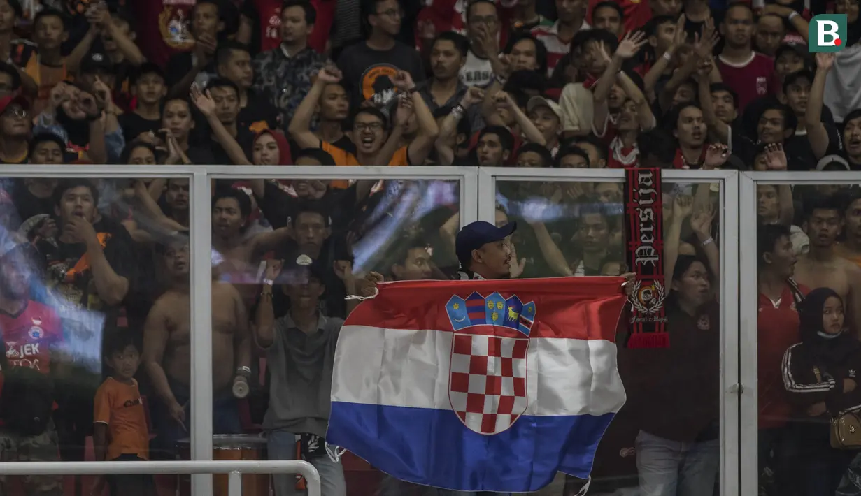 Suporter Persija Jakarta, The Jakmania, membawa bendera negara asal Marko Simic, Kroasia, saat melawan Bali United pada final Piala Presiden di SUGBK, Jakarta, Sabtu (17/2/2018). Persija menang 3-0 atas Bali United. (Bola.com/Vitalis Yogi Trisna)