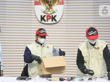 Ketua Komisi Pemberantasan Korupsi (KPK), Setyo Budiyanto (kiri) menyaksikan petugas yang akan memperlihatkan barang bukti Operasi Tangkap Tangan (OTT) di Kantor Imigrasi Jakarta Barat, Gedung Merah Putih KPK, Jakarta, Kamis (4/6/2026). (Liputan6.com/Helmi Fithriansyah)