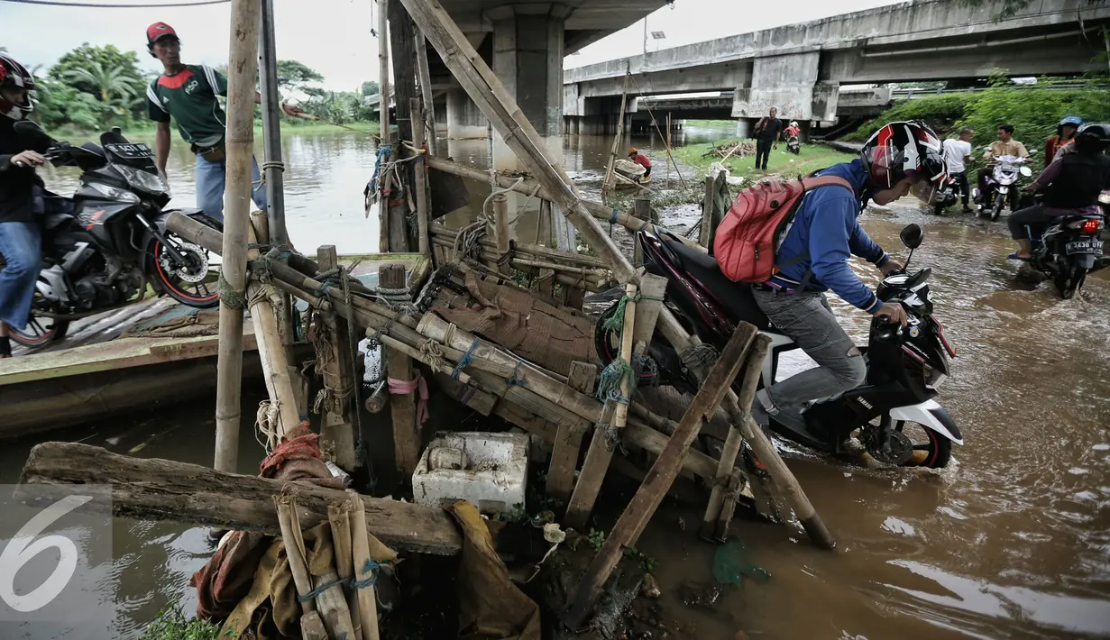 Pengendara motor turun usai menyeberang Kanal Banjir Barat (KBB) dengan menggunakan perahu eretan di kawasan Teluk Gong, Jakarta, Rabu (10/2/2016). (Liputan6.com/Faizal Fanani)