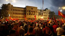 Kerumunan orang memprotes di depan gedung parlemen di Skopje, Makedonia Utara, Selasa (5/7/2022). Protes terjadi  setelah Prancis Presiden Emmanuel Macron pekan lalu mengumumkan proposal itu, yang dianggap kontroversial oleh banyak orang di negara kecil Balkan itu. (AP Photo/Boris Gdanoski)