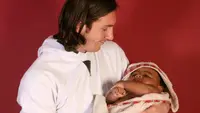 Lionel Messi bersama Lamine Yamal sewaktu bayi (Joan Monfort/AP)