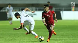 Pemain sayap Indonesia U-23, Febri Hariyadi (kanan) melewati adangan pemain Korea Selatan U-23, Kim Jeung Ho pada laga persahabatan di Stadion Pakansari, Kab Bogor, Sabtu (23/6). Indonesia U-23 kalah 1-2. (Liputan6.com/Helmi Fithriansyah)