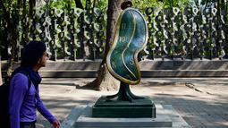 Seorang pria melihat patung " Dance of Time I " saat pameran "Salvador Dali: Urban Dreams" di Mexico City, Selasa (14/3). Patung-patung tersebut adalah karya seniman asal spanyol yang bernama Salvador Dali. (AFP PHOTO / RONALDO SCHEMIDT)