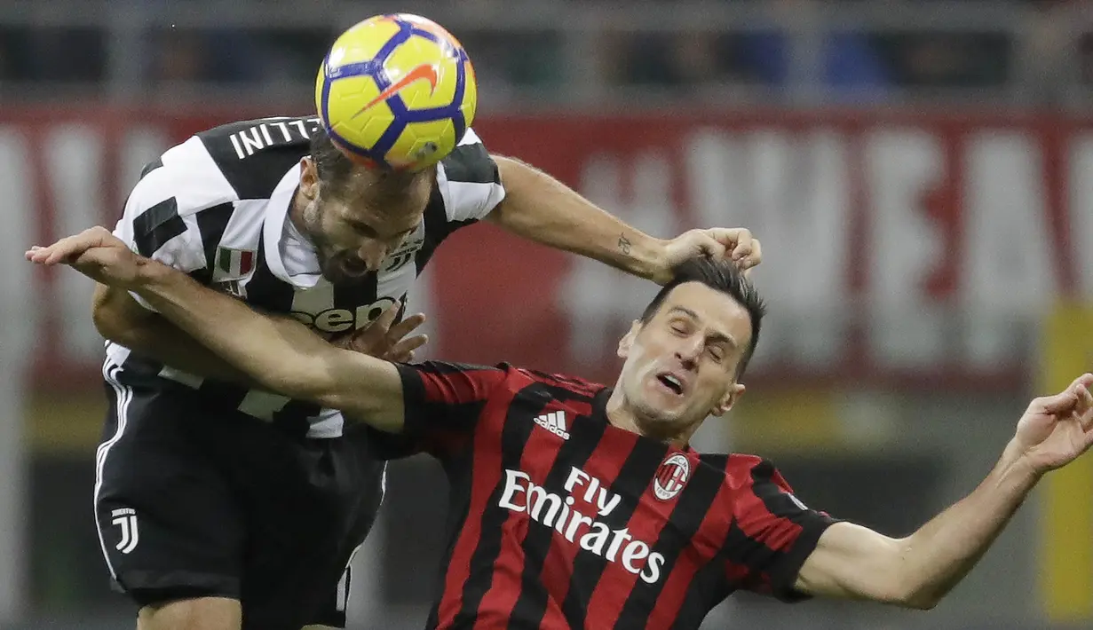 Bek Juventus, Giorgio Chiellini, duel udara dengan striker AC Milan, Nikola Kalinic, pada laga Serie A di Stadion San Siro, Sabtu (28/10/2017). AC Milan Takluk 0-2 dari Juventus. (AP/Luca Bruno)